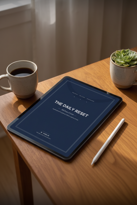 The Daily Reset 365-day wellness journal displayed on tablet with coffee and succulent"